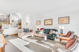 a living room with two couches and a table at Morning Crescendo in Frisco