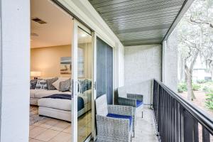 a balcony with chairs and a couch in a room at Surf Court Villas 5 in Hilton Head Island