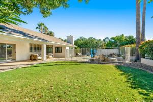 a house with a fence and a yard at Paradise in the Valley in Phoenix