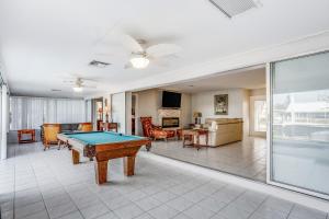 a living room with a pool table in it at Norma on the Canal in Punta Gorda