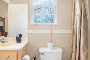 a bathroom with a toilet and a window at Rest Assured, WIFI, 685 FREE tickets each paid day!!! in Pigeon Forge +45 photos