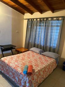 a bedroom with a bed with two towels on it at Panela Coffee Hostel in Medellín