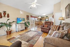 a living room with leather furniture and a flat screen tv at River Breeze, WIFI, 685 FREE tickets each paid day!!! in Pigeon Forge