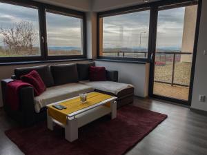 a living room with a couch and a coffee table at Cozy Residental Apartment in Košice