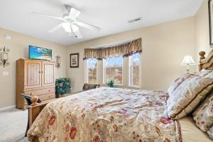 a bedroom with a bed and a ceiling fan at River Breeze, WIFI, 685 FREE tickets each paid day!!! in Pigeon Forge
