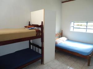 a bedroom with two bunk beds and a window at Estalagem das Estrelas in Cristalina +20 photos