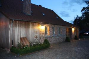 a brick house with lights on the side of it at B&B Hooglandhoeve in Geel