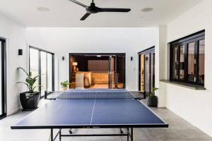 a ping pong table in the middle of a room at White Hut on Golflinks in Kingston South East