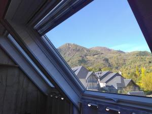a view from the window of a house with mountains at Chezmaryline in Vielle-Aure