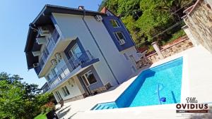 a house with a swimming pool in front of it at Arode Villa Ovidius in Balchik