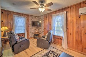 a living room with two chairs and a tv at Cozy Knoxville Getaway about 8 Mi to Downtown! in Knoxville