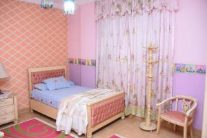 Postel nebo postele na pokoji v ubytování Kenzy guest house