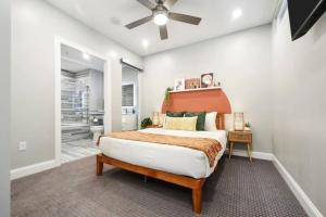 a bedroom with a large bed with an orange headboard at HostWise Stays - The Washington at Chatham - Free Parking, Private Gym, More! in Pittsburgh