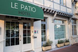 a building with a sign that reads la palma hotel at Hôtel Le Patio - Deauville in Deauville