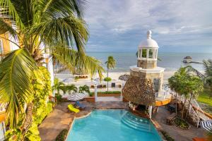 a resort with a swimming pool and a lighthouse at Lighthouse Beach Villas in San Pedro +143 photos