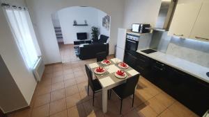 a kitchen with a table with four plates of food on it at La caverne de la rose d'or in Orange