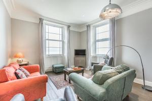 a living room with two couches and a tv at Pier View in Weston-super-Mare