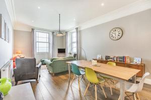 a living room with a dining room table and chairs at Pier View in Weston-super-Mare