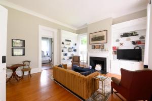 a living room with a couch and a fireplace at Rose Hill Inn in Versailles