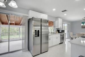 a kitchen with a stainless steel refrigerator at Just Remodeled! Close to All! 3 Miles to Beach!! 2 Miles From Airport! in West Palm Beach