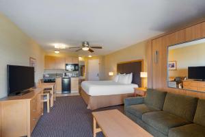 a hotel room with a bed and a couch at Best Western Plus Ocean View Resort in Seaside
