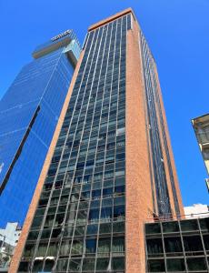 a tall red brick building with glass windows at TroBaires in Buenos Aires +14 photos