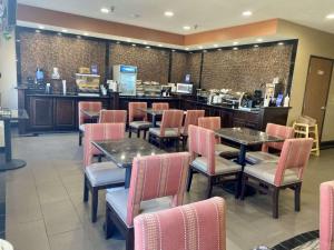 a restaurant with tables and chairs and a counter at Best Western Emporia Inn in Emporia