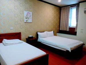 Postel nebo postele na pokoji v ubytování Ju Jia Xiao Zhan Homestay