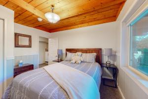 a bedroom with a bed with a teddy bear on it at The Retreat on Wabash Lane in Lake Arrowhead