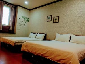 Postel nebo postele na pokoji v ubytování Ju Jia Xiao Zhan Homestay