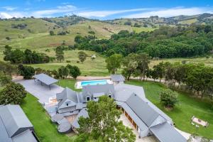 an aerial view of a house in a field at The Estate Main House Byron Bay in Bangalow