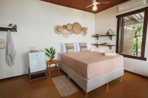 a bedroom with a large bed and a window at Pousada Pouso da Maré in Ilha de Boipeba