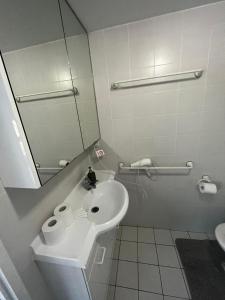 a bathroom with a sink and a mirror at Private room with ensuite in the CBD in Canberra