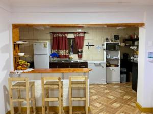 a kitchen with a counter and some white appliances at Hostal Familiar S&G in Santiago