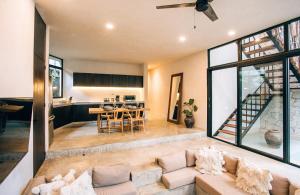 a living room with a couch and a table at Round Luxury Villa Private Pool Soona 4A in Tulum