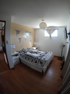 a bedroom with a large bed and a window at Complejo Santa Ana Miramar Buenos Aires in Miramar