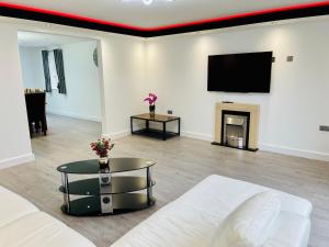 a living room with a couch and a fireplace at 4-Bedroom Cottage in Healing, Grimsby in Grimsby