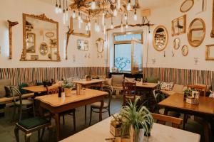 a restaurant with wooden tables and chairs and a window at The Keep Eco Rooms in Salzburg