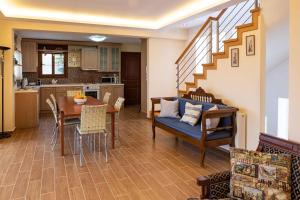 a kitchen and living room with a table and chairs at VillaAriadniNafplion in Nafplio