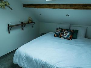 a bedroom with a white bed with a pillow on it at Holiday home Aywaille in Aywaille