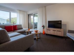 a living room with a couch and a flat screen tv at Luxury Apartment in Kamperland in Kamperland
