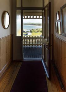 an open door to a room with a view of the ocean at Stanley Hotel & Apartments in Stanley