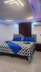 a bedroom with a bed with blue lights on it at SANTIAGO CITY in Santiago de los Caballeros +58 photos