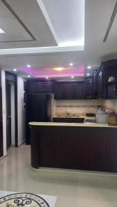 a kitchen with black cabinets and a counter top at SANTIAGO CITY in Santiago de los Caballeros