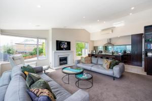 a living room with a couch and a fireplace at Luxury Lakeview Vista Apartment in Wanaka