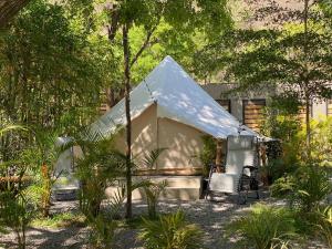 a tent and two chairs in front of a house at Punta Santa Maria in Santa María del Oro
