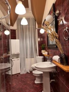 a bathroom with a shower and a toilet and a sink at Artist Apartment in Braşov