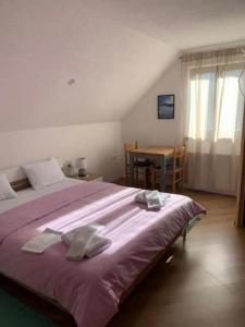 Holiday house with a parking space Cujica Krcevina, Plitvice - 20257 في بليتفيتْشكا ييزيرا: غرفة نوم بسرير كبير عليها مناشف