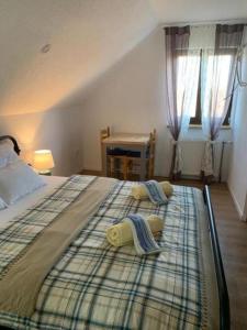 a bedroom with a large bed with two pillows on it at Holiday house with a parking space Cujica Krcevina, Plitvice - 20257 in Plitvička Jezera