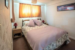 a bedroom with a bed with two pillows on it at Park View 'Home Away From Home' in Feilding